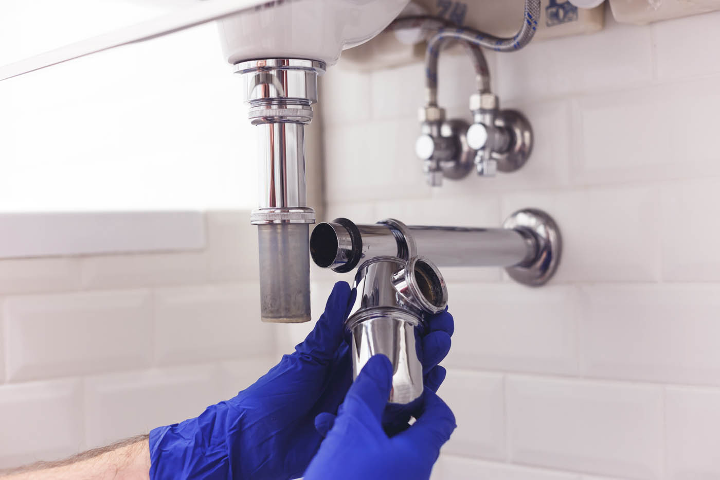 A plumber from Zest repair's a pipe - learn how you can prepare your plumbing for the summer with our tips!