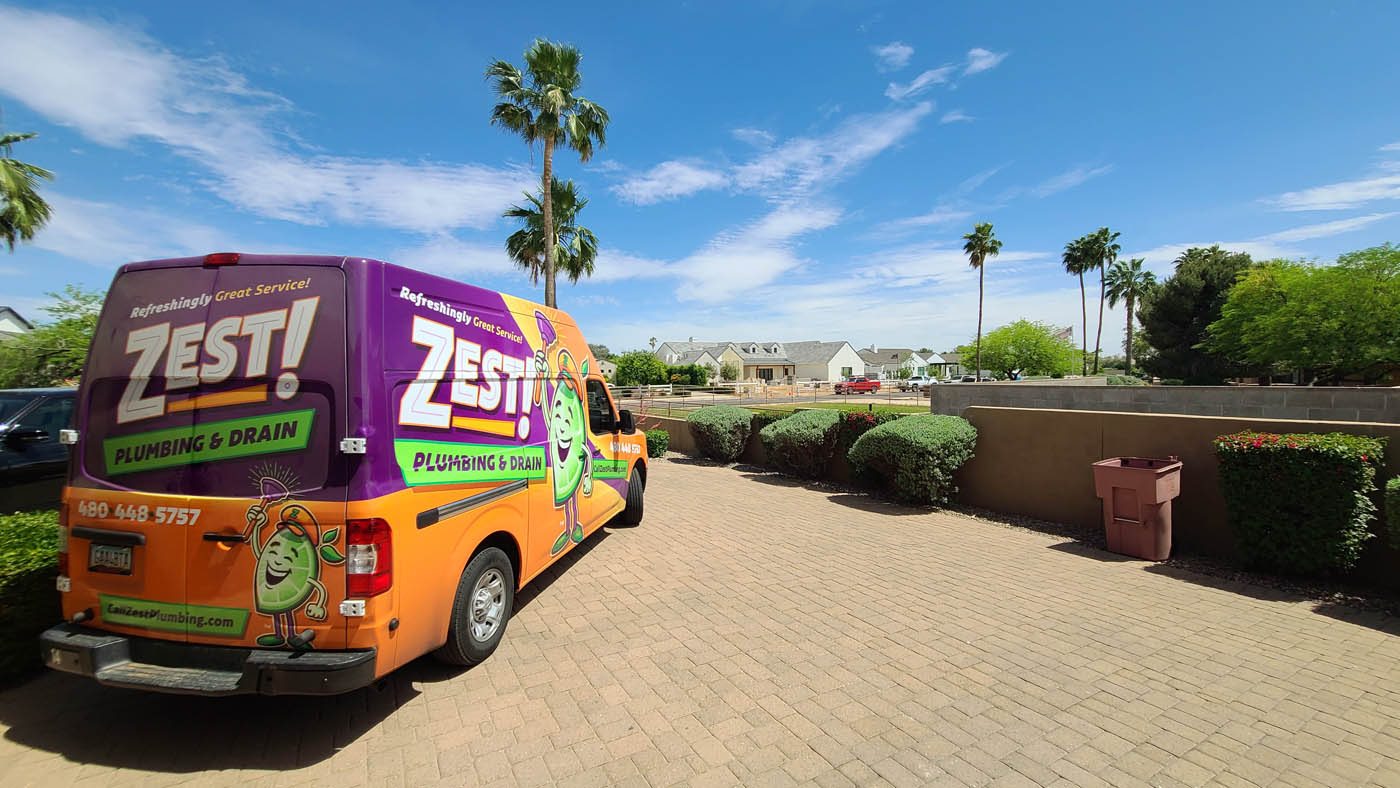 A Zest Plumbing & Drain technicians van drain cleaning and plumbers in Surprise inspecting a home.