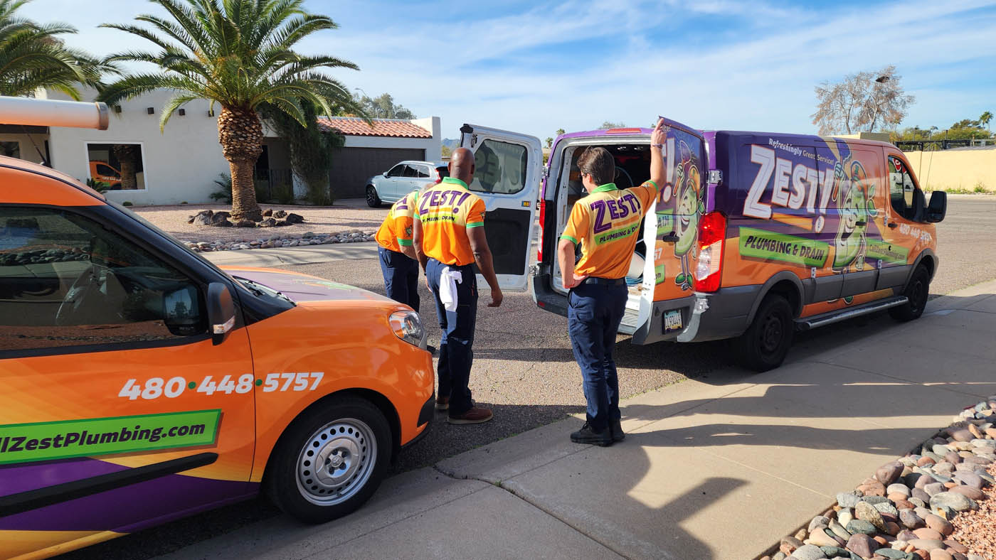 A group of Zest Plumbing & Drain technicians and our vehicles - discover what our professional services can do for you.