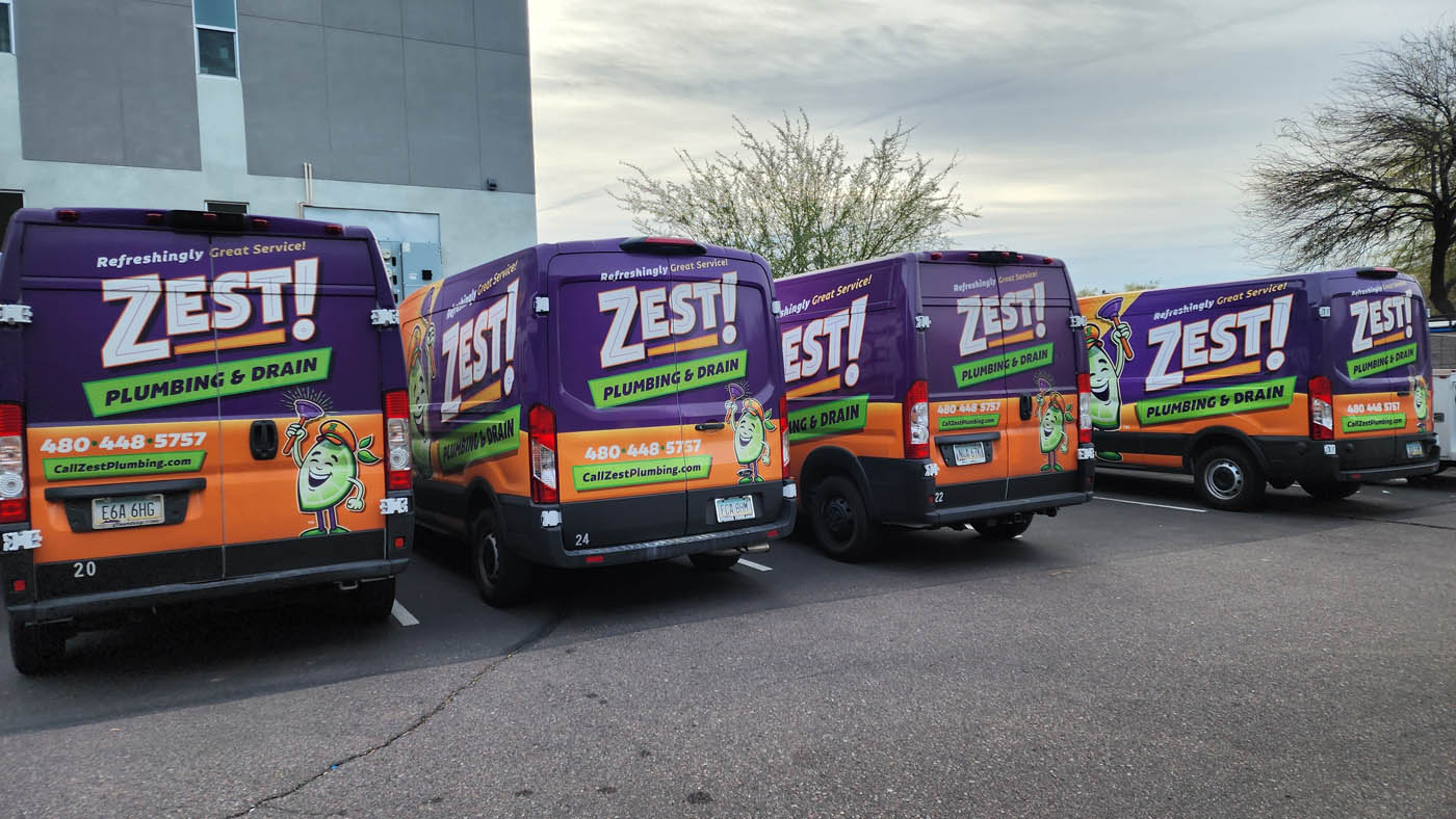 A row of Zest Plumbing & Drain's affordable plumbing trucks in Scottsdale, AZ.