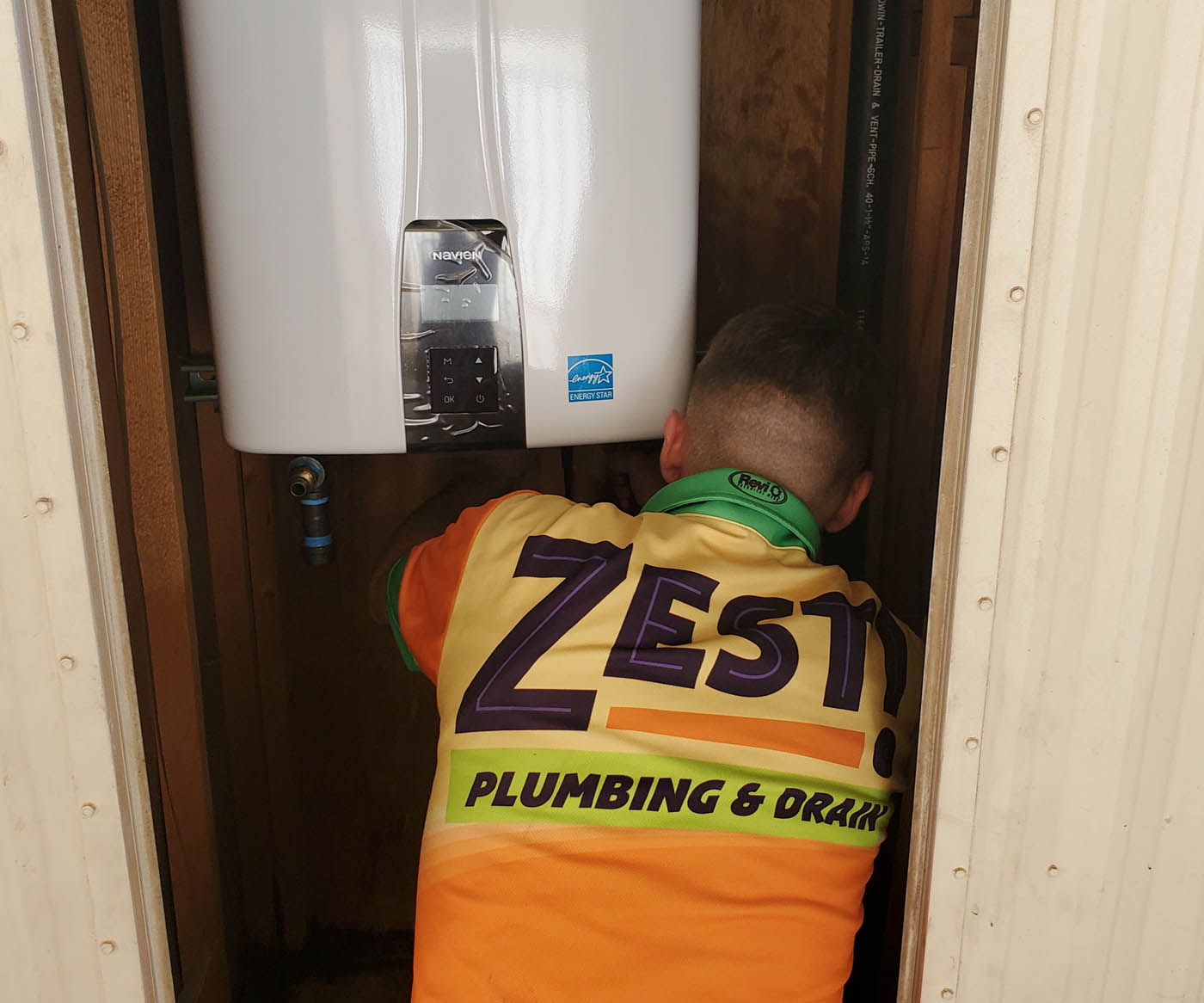 A Zest Plumbing & Drain technician working on a water heater service in Scottsdale, AZ.