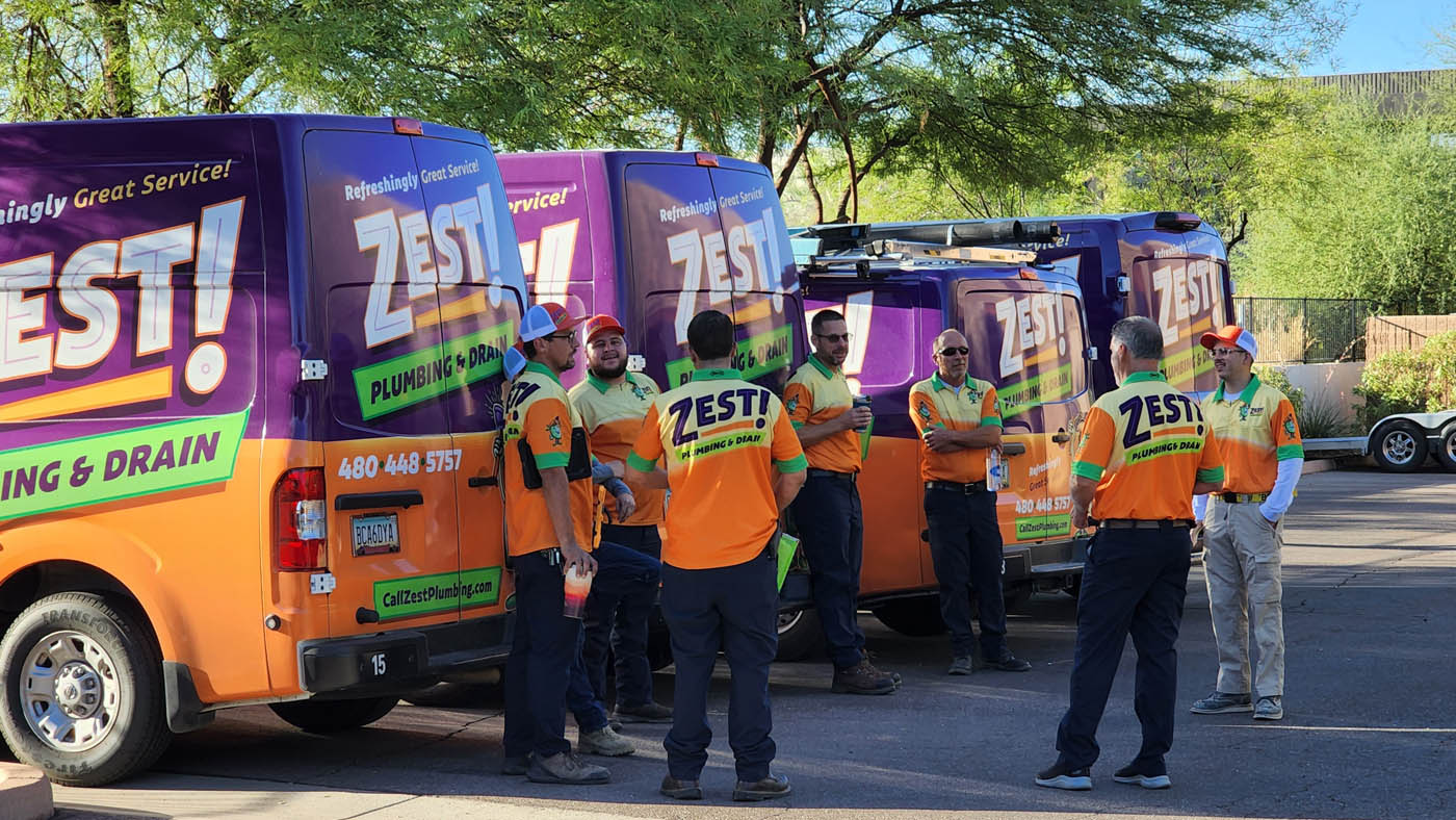 Zest technicians standing by their trucks.