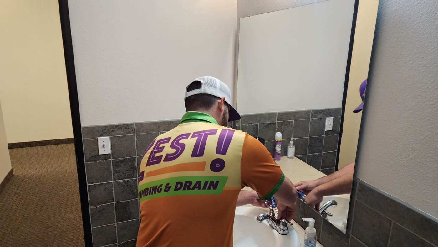 A Zest Plumbing & Drain plumber working on a bathroom in Scottsdale.