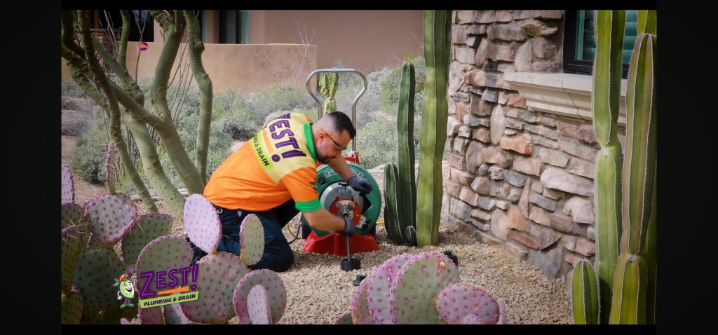Plumber is Using a Large Mechanical Sewer Root Cutting Machine to Clear Blockage in Mainline Sewer. Mainline Drain Cleaning | Zest Plumbing & Drain