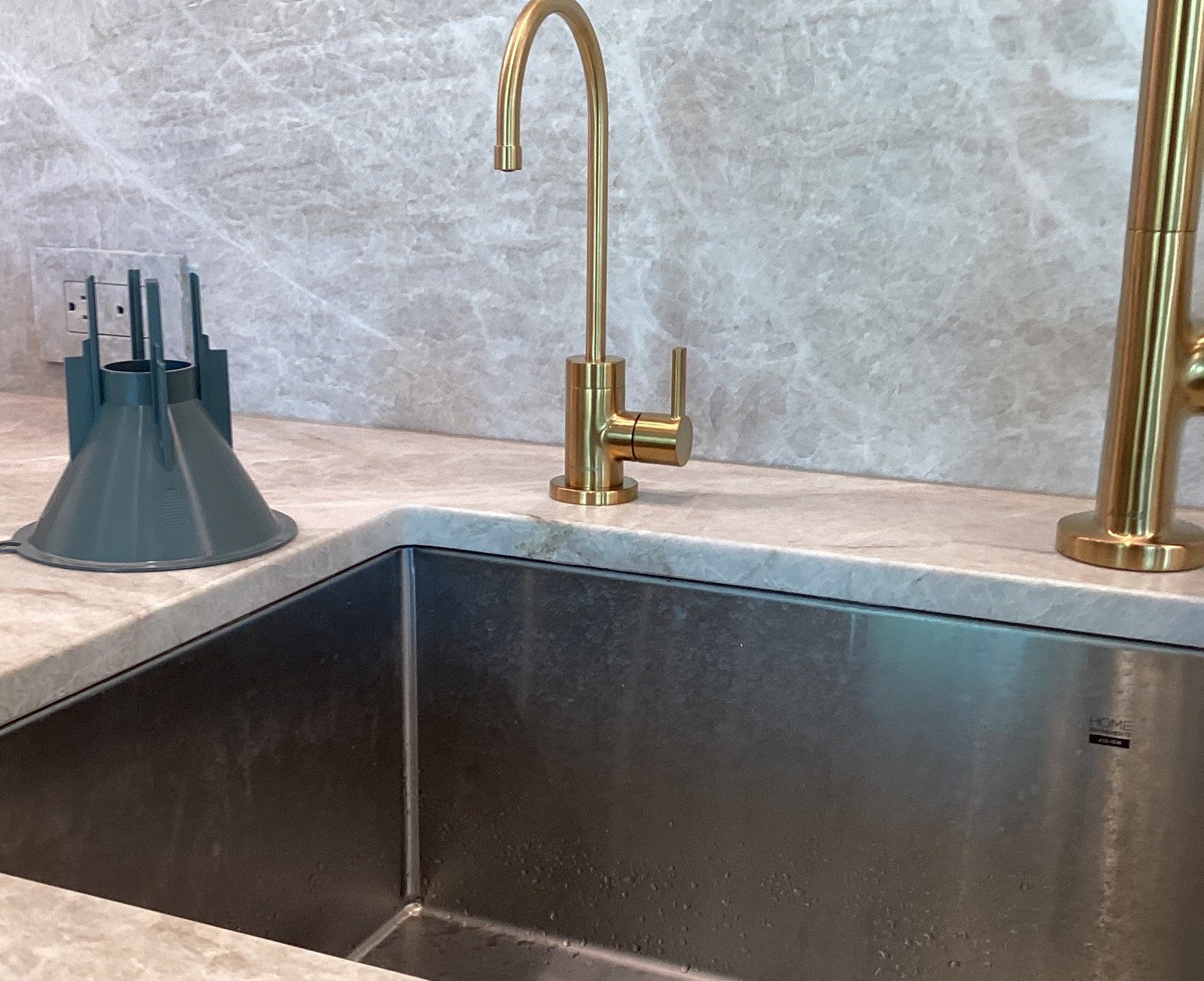 Brushed gold customer-supplied RO faucet installed at a kitchen sink with a stainless basin and marble countertop in Troon North, North Scottsdale.